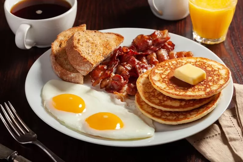 pancakes, toast, eggs, and bacon